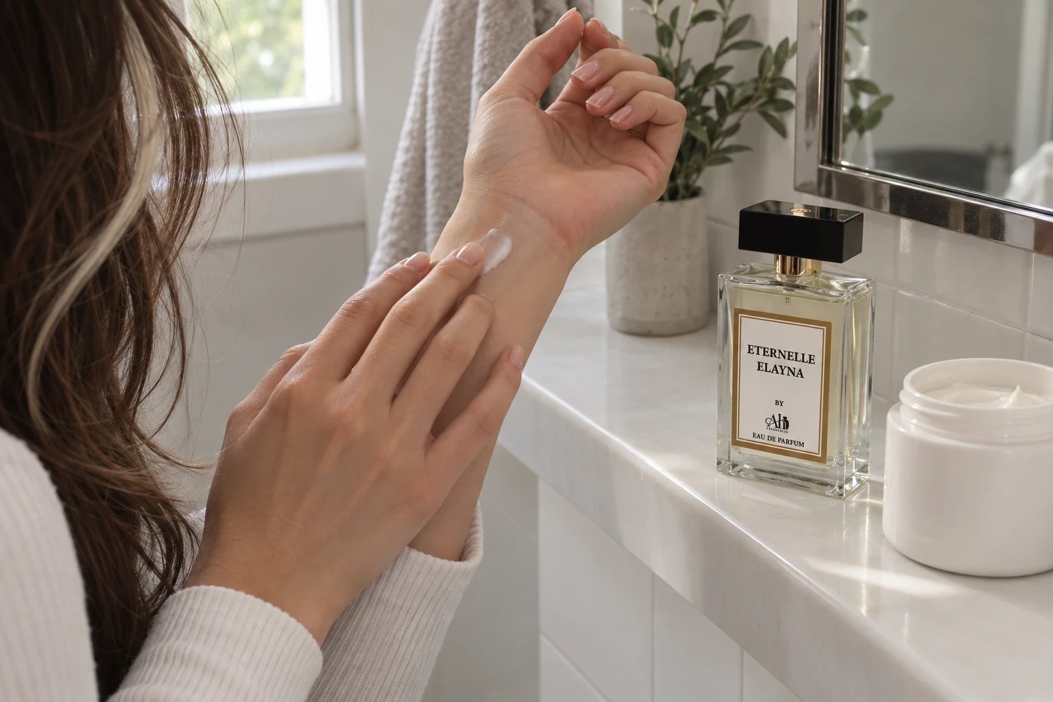 Hands smoothing unscented moisturiser onto an inner wrist before applying perfume